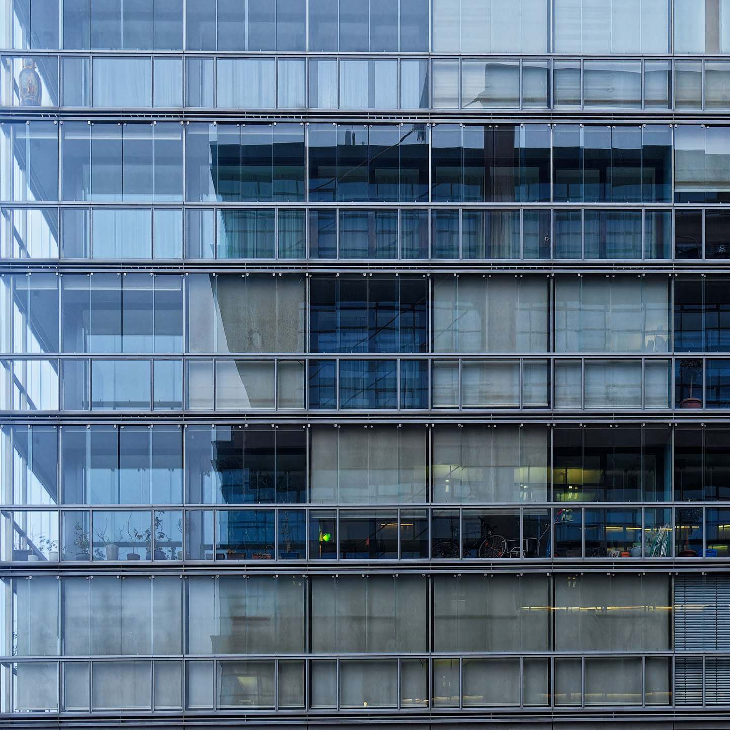 Urban office building exterior on a city street, contemporary glass facade of a modern office building